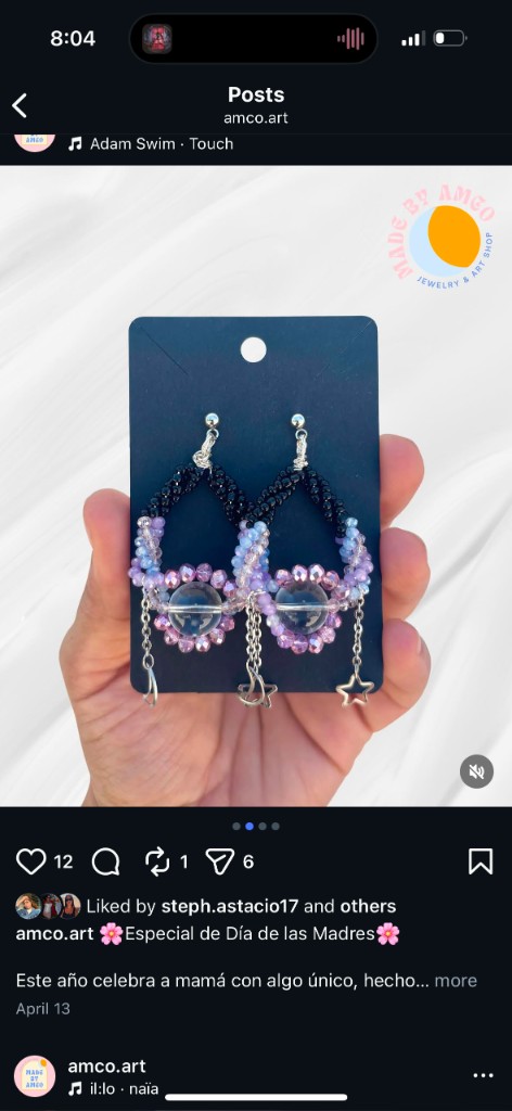 Handmade beaded earrings with a clear center bead, moon and star charms on stud posts.