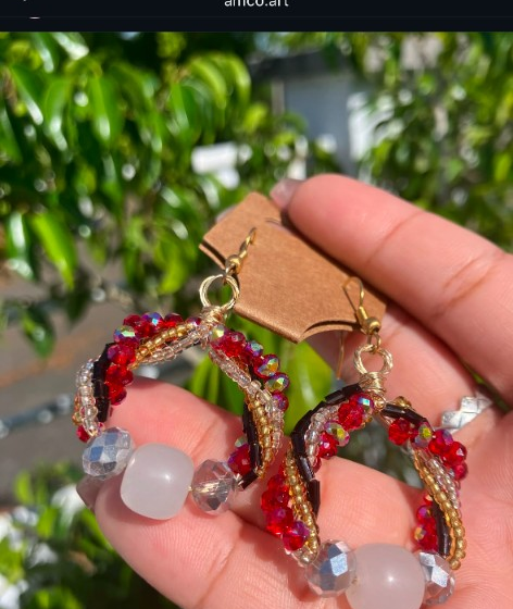 Handmade hoop earrings with red and gold seed beads, faceted crystal accents, and large milky white focal beads on fishhook wires.